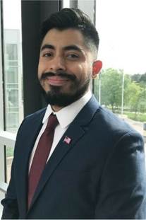 A person in a suit smiling

AI-generated content may be incorrect.